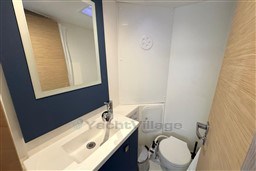 Modern bathroom in 2024 Fountaine Pajot Isla 40 yacht, featuring sleek sink and compact toilet.