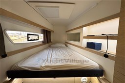 2024 Fountaine Pajot Isla 40 cabin interior with bed, window, and shelving.