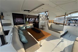 2024 Fountaine Pajot Isla 40 catamaran interior with seating, table, and helm station.