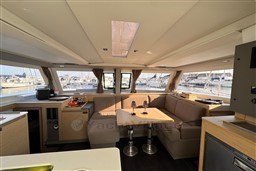 Luxurious interior of 2024 Fountaine Pajot Isla 40 catamaran with spacious seating and panoramic windows.