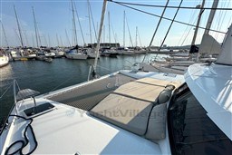 2024 Fountaine Pajot Isla 40 catamaran docked in a marina, featuring spacious deck seating.