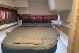 Interior cabin of 2024 Fountaine Pajot Isla 40 catamaran with cozy bed and modern design.