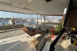 Luxurious 2024 Fountaine Pajot Isla 40 catamaran interior with marina view.