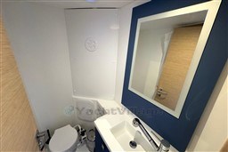 Modern bathroom in 2024 Fountaine Pajot Isla 40 catamaran with sink, mirror, and toilet.