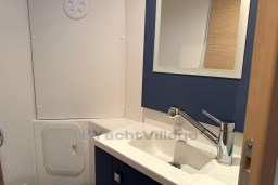 Bathroom interior of 2024 Fountaine Pajot Isla 40 catamaran, featuring modern sink and mirror.