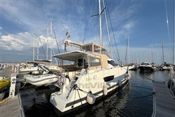 2024 Fountaine Pajot Isla 40 catamaran docked at marina under clear blue sky.
