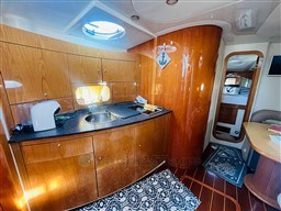 Luxurious 2005 Innovazione e Progetti Mira 43 yacht interior with wooden cabinetry and modern amenities.