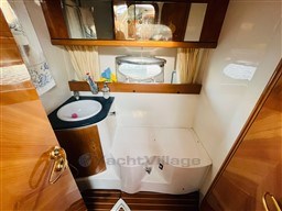 Luxurious bathroom in 2005 Innovazione e Progetti Mira 43 yacht, featuring wooden accents and modern fixtures.