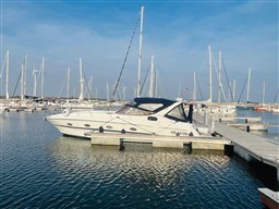 2005 Innovazione e Progetti Mira 43 yacht docked in a marina under clear skies.