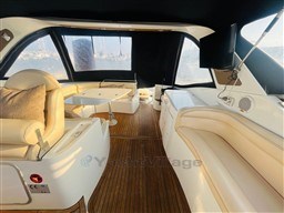 Luxurious interior of 2005 Innovazione e Progetti Mira 43 yacht with elegant seating and wooden flooring.
