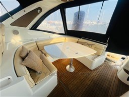 Luxurious seating area on 2005 Innovazione e Progetti Mira 43 yacht with wooden flooring.