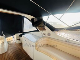 2005 Innovazione e Progetti Mira 43 yacht interior with seating and mounted TV.