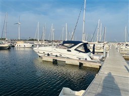 2005 Innovazione e Progetti Mira 43 yacht docked in a marina under clear blue skies.
