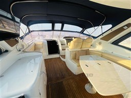 Luxurious 2005 Innovazione e Progetti Mira 43 yacht interior with elegant seating and wooden flooring.