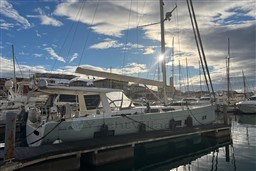 Sailing yacht Hanse 588, 2017 model, docked at marina under a partly cloudy sky.