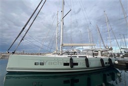 Sailing yacht Hanse 588, 2017 model, docked at marina under cloudy sky.