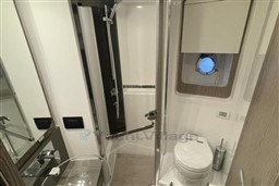 Luxurious 2020 Azimut S6 yacht bathroom with modern shower and porthole window.