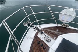Bow of 2020 Azimut S6 yacht with teak decking and stainless steel railings.