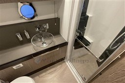 Luxurious 2020 Azimut S6 yacht bathroom with modern glass sink and shower.