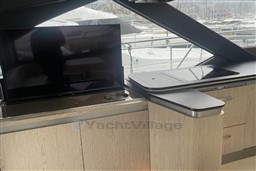 Interior of 2020 Azimut S6 yacht with modern cabinetry and a flat-screen TV.