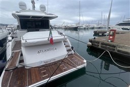Azimut S6 2020 yacht docked at marina, featuring wooden deck and Italian flag.