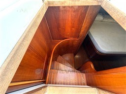 Wooden staircase leading to cabin interior of 2000 Rizzardi CR 53 Top Line yacht.