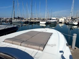 Rizzardi CR 53 Top Line yacht docked in marina, surrounded by sailboats, clear blue sky.