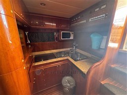 Luxurious wooden kitchen interior of 2000 Rizzardi CR 53 Top Line yacht.