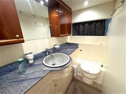 Luxurious bathroom in 2000 Rizzardi CR 53 Top Line yacht with elegant fixtures and wood cabinetry.