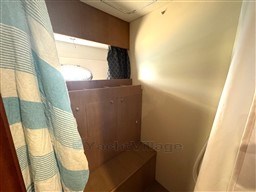 Interior of 2000 Rizzardi CR 53 Top Line yacht with wooden cabinetry and striped towel.