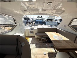 Interior view of 2000 Rizzardi CR 53 Top Line yacht with wooden deck and seating area.