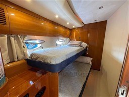 Luxurious 2002 Princess V65 yacht cabin with wooden interior and bunk beds.
