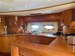 Luxurious wooden interior of a 2002 Princess V65 yacht kitchen area.