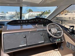 Cockpit of 2002 Princess V65 yacht with steering wheel and navigation equipment.