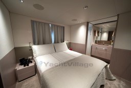 Luxurious bedroom interior of 2022 Sanlorenzo SD96 yacht, featuring elegant design and modern amenities.