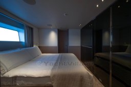 Luxurious bedroom interior of 2022 Sanlorenzo SD96 yacht with modern design and ambient lighting.