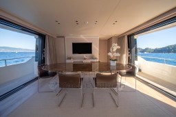 Luxurious interior of 2022 Sanlorenzo SD96 yacht with ocean view and elegant dining area.
