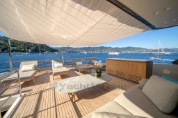 Luxurious 2022 Sanlorenzo SD96 yacht deck with elegant seating and stunning ocean view.