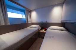 Luxurious twin cabin on 2022 Sanlorenzo SD96 yacht, featuring modern design and ambient lighting.