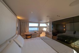Luxurious Sanlorenzo SD96 2022 yacht bedroom with ocean view and elegant decor.