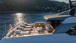 Luxurious 2022 Sanlorenzo SD96 yacht deck with sun loungers and scenic ocean view.