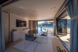 Luxurious interior of 2022 Sanlorenzo SD96 yacht with ocean view and modern furnishings.