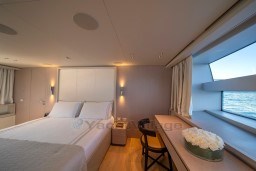 Luxurious Sanlorenzo SD96 2022 yacht bedroom with ocean view, elegant decor, and modern furnishings.