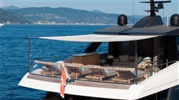 Luxurious 2022 Sanlorenzo SD96 yacht with elegant deck, scenic ocean backdrop.