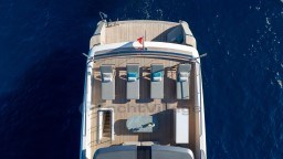 Aerial view of 2022 Sanlorenzo SD96 yacht deck with sun loungers and table.