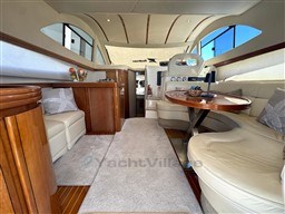 Luxurious interior of a 2002 Rodman 38fly yacht with elegant seating and wooden accents.
