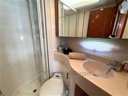 Luxurious bathroom in a 2002 Rodman 38fly yacht with modern fixtures and shower.