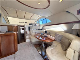 Luxurious interior of a 2002 Rodman 38fly yacht with elegant seating and wooden accents.