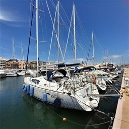 Beneteau Oceanis 43 sailboat docked in marina, 2008 model, clear blue sky.