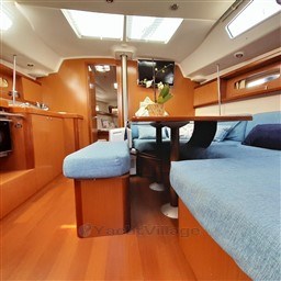 Interior of 2008 Beneteau Oceanis 43 yacht with blue seating and wooden finishes.